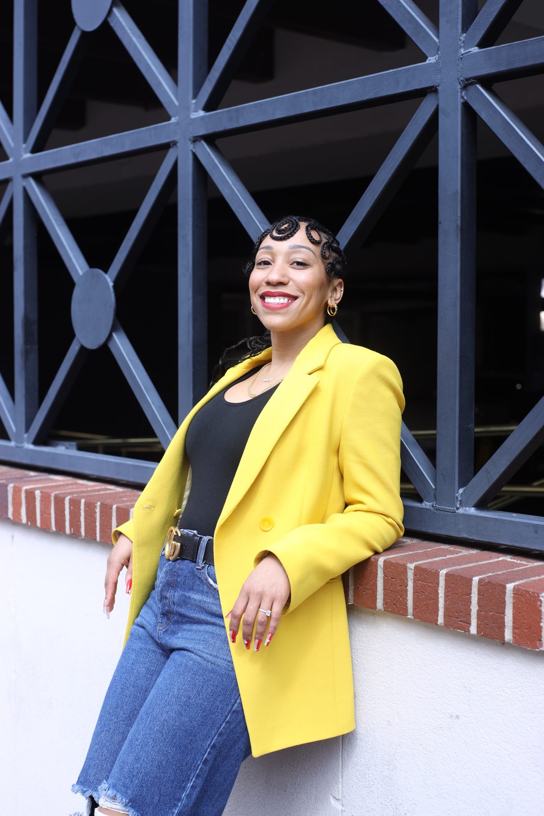 Kim Woodard, founder of Woodard & Co., wearing a yellow blazer.
